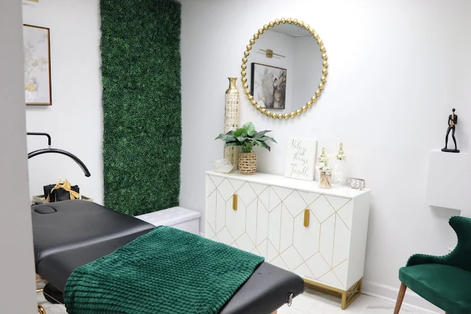 Emerald green treatment room with gold mirror at Little Rock Day Spa